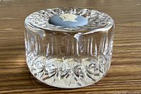 Side view showing cylindrical cut crystal body and jasper medallion on top