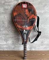 Front view of Wilson racket inside cover showing branding and graphic