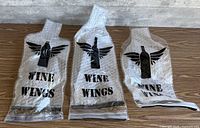 Three Wine Wings bubble-wrap bottle sleeves on table