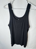 Front view of black ribbed scoop neck tank top on hanger