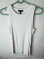 Front view of white ribbed tank top on hanger