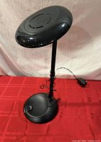 Full view of lamp showing head, pole, base and cord