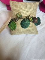 Bracelet on display pillow showing charms and tag
