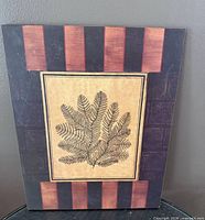 Front view of wood panel showing fern image and border