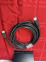 Coiled 30 ft black HDMI cable showing both male connectors and overall length