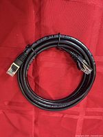 Full view of coiled black Cat6 STP Ethernet cable with RJ45 connectors