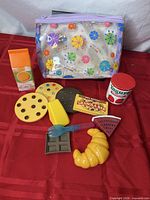 Entire set of play food items spread out with storage pouch visible