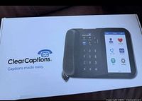 Sealed retail box showing ClearCaptions Blue phone image and branding