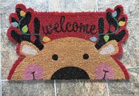 Front view of reindeer welcome coir mat showing design and colours