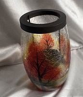 Full side view of crackle glass candle holder showing painted autumn trees motif