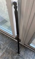 Full length view of wooden walking stick leaning against door