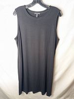 Front view of black sleeveless Eileen Fisher dress on hanger