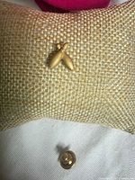 Front view of crossed bowling pin lapel pin on fabric display
