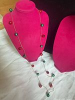 Full view of opera-length necklace on display bust showing overall design and bead spacing