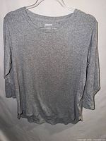 Front view of gray 3/4 sleeve Kirkland Signature cotton T-shirt on hanger