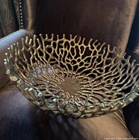 Top view of openwork cast metal bowl on chair