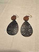 Front view of both leather and wood earrings showing materials and design