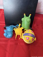 Front view of all four keychain toys against dark background