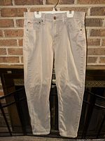 Front view of beige Lucky Brand pants hanging