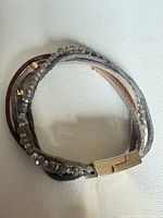 Bracelet showing suede strands, beads, and clasp