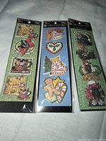 All three sealed packs of dimensional holiday stickers displayed front packaging