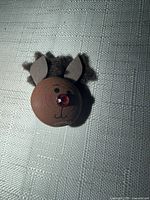 Front view of reindeer brooch showing face, nose, ears and antlers