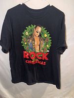 Full view of black WWE The Rock Christmas T-shirt on hanger