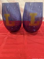 Front view showing both glasses and "L" decals