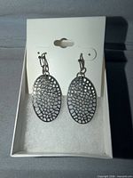 Front view of earrings on card inside box