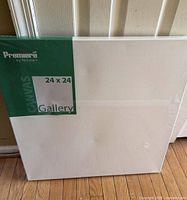 Front view of shrink-wrapped 24 x 24 canvas with label