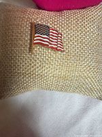 Front view of gold-tone American flag enamel lapel pin