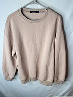 Front view of beige Trendy Queen crewneck sweatshirt on hanger