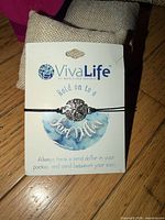 Front of retail card showing bracelet and VivaLife branding