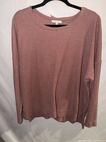 Front view of mauve waffle knit long sleeve top on hanger