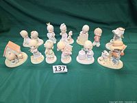 Full group of 12 Precious Moments figurines displayed in two rows