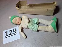 Full view of doll with box and lot number