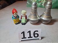 Full lot showing ceramic figurine pair and aluminum pair