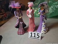 Front view of three figurines standing side by side