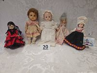 Group shot of five vintage dolls standing