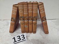 All six books standing showing spines