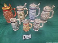 Group shot of all seven steins and mugs