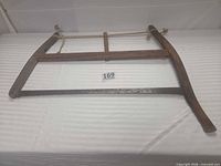 Full view of wooden frame buck saw showing overall structure and blade