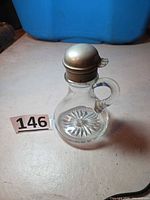 Full view of whiskey noggin showing lid, handle and glass body