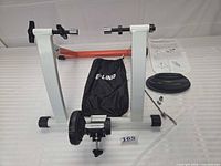 overall view of trainer stand, riser block, hardware, bag and instructions
