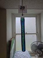 Full view of hanging glass rod against window