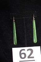 Full view of both jade drop earrings on stand