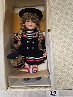 Full boxed view of Julie porcelain doll, teddy bear, stand