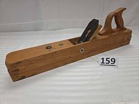 Side view of wooden jointer plane showing body, tote, iron and wedge
