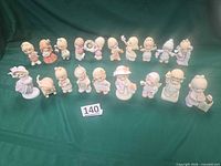 Group shot of 19 Precious Moments annual figurines