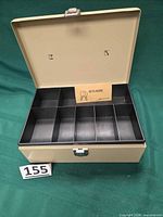 Cash box open showing interior tray and keys card